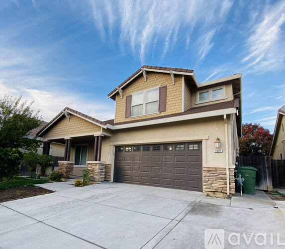 A two-story house with a garage is for sale.