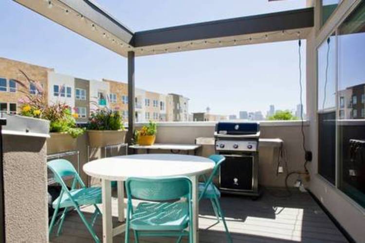 A patio with a table and chairs is set up on a balcony.