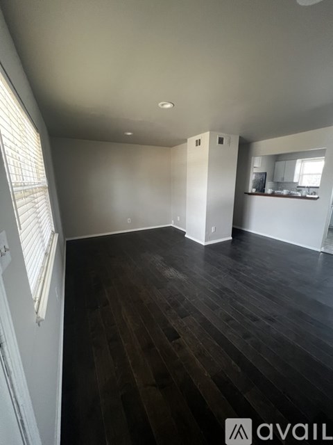 A room with wooden floors and white walls.
