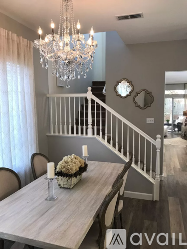 A dining room with a wooden table and chairs.
