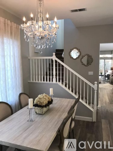 A dining room with a wooden table and chairs.
