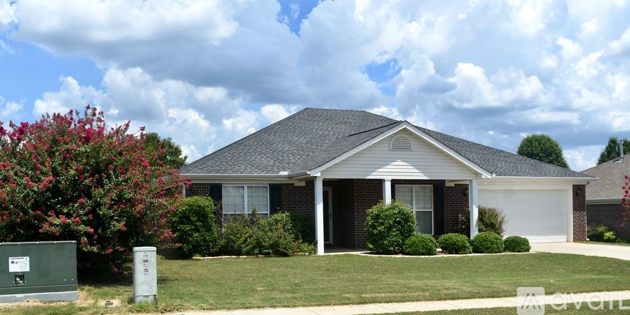 A house with a grey roof and a white garage door.