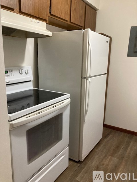 A white oven and refrigerator in a kitchen.