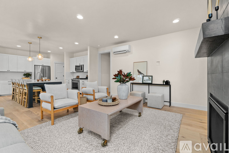 A modern living room with a grey sofa and a coffee table.