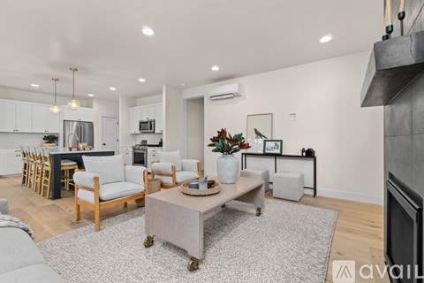 A modern living room with a grey sofa and a coffee table.