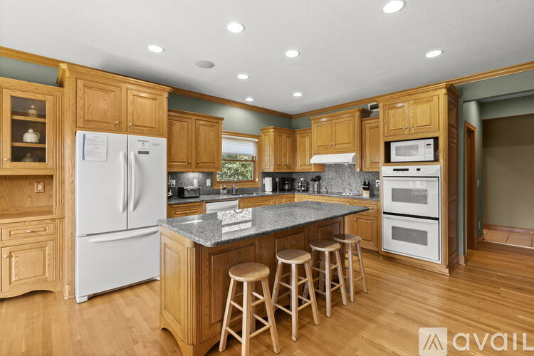 A kitchen with wooden cabinets and a white refrigerator.