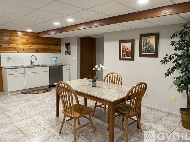 A dining room with a table and chairs.