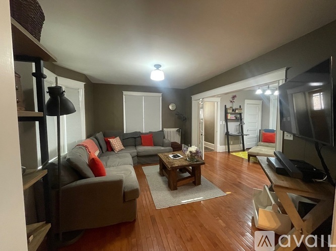 A living room with a grey couch and a wooden coffee table.