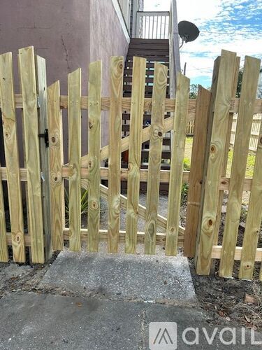 A wooden fence in front of a house.