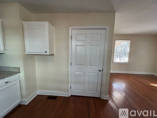 A room with a white door and a window with a white frame.