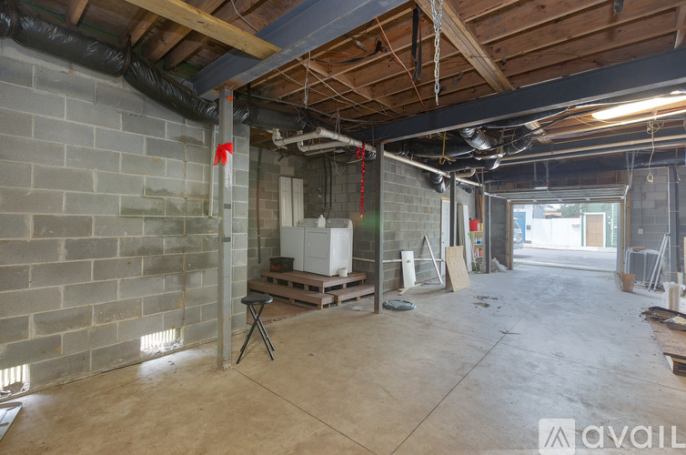 A room under construction with exposed wooden beams and unfinished walls.