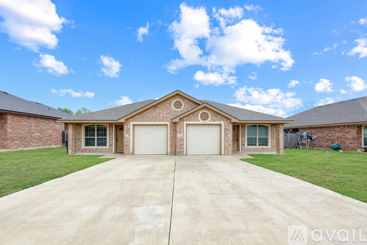 A house with a brown roof and a white garage door.