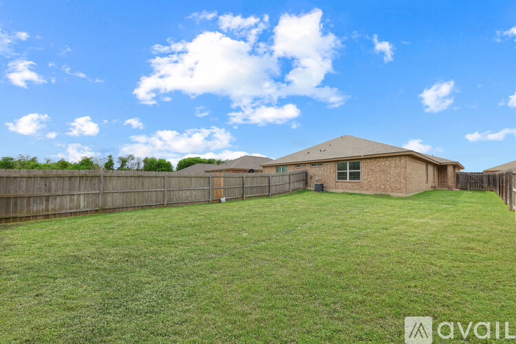 A house with a fence and a grassy yard is available for sale.