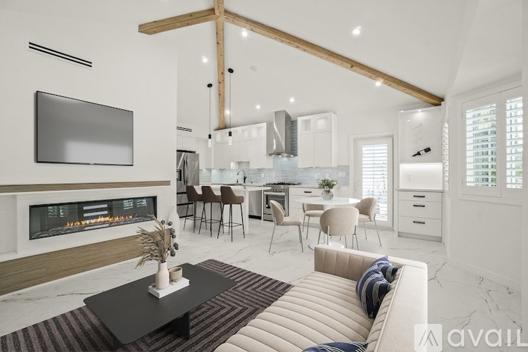 A modern living room with a fireplace and a television.