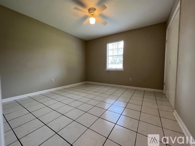 A room with a ceiling fan and a window.