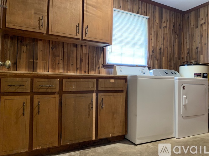 A kitchen with wooden cabinets and a white oven.