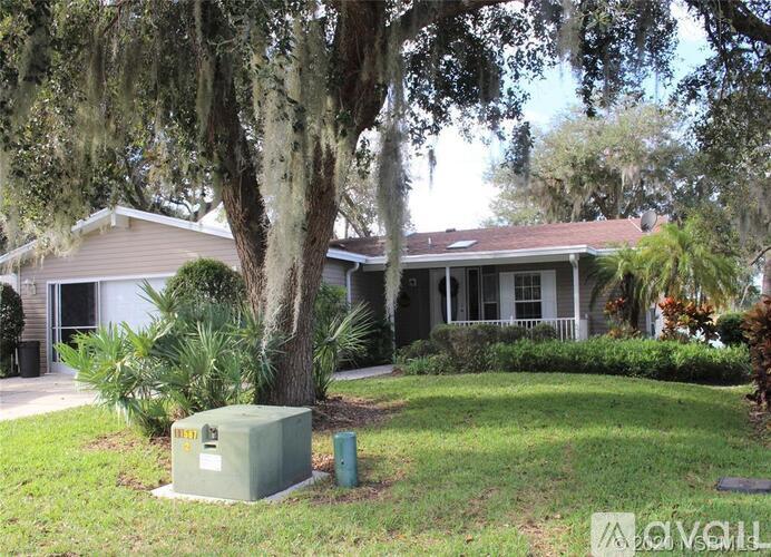 A house with a tree in front of it.
