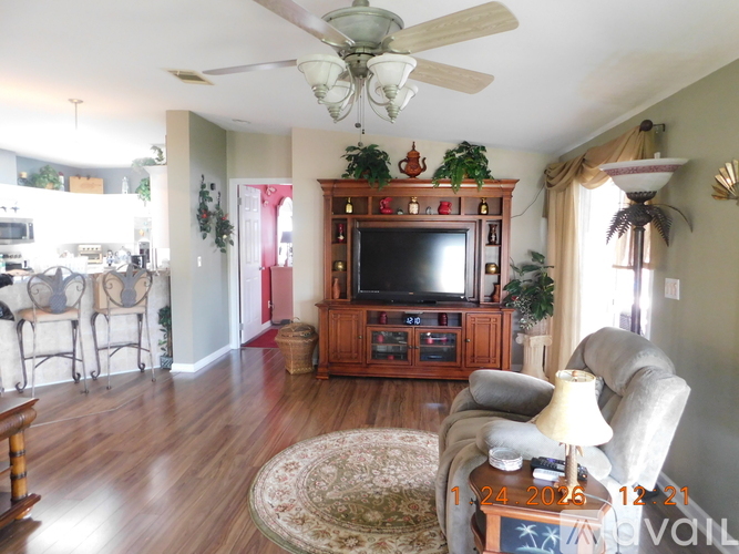 A living room with a television and a couch.