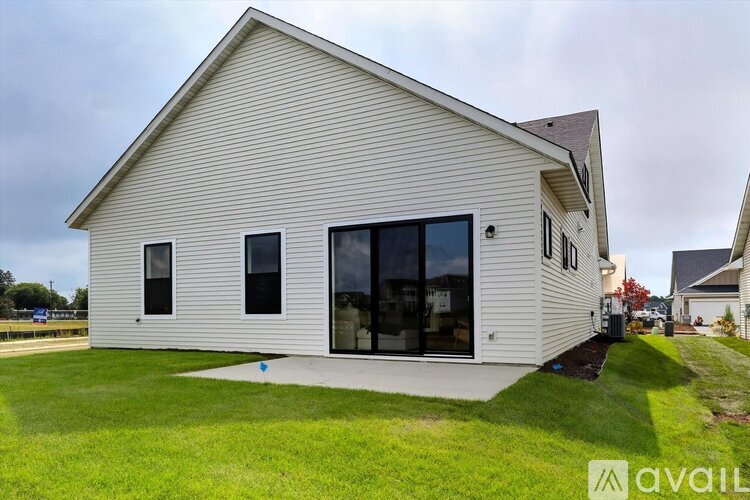 A house with a white exterior and a grey roof is available for sale.