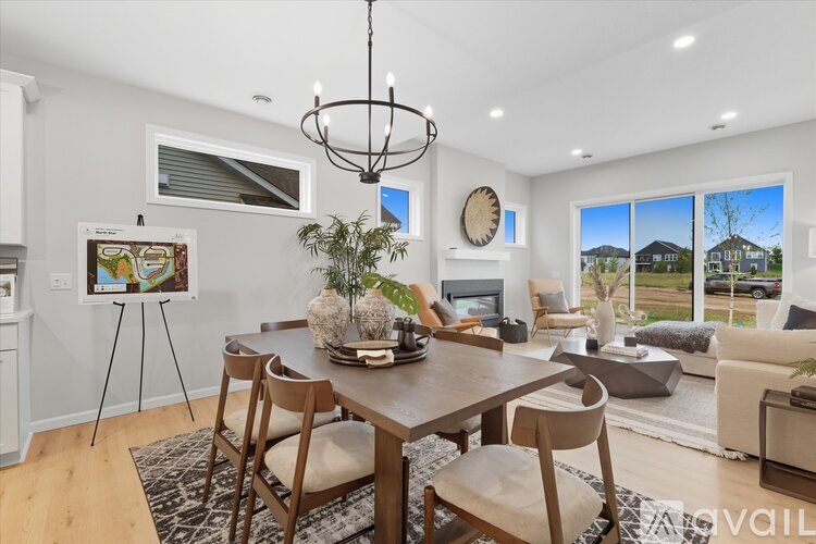 A dining room with a wooden table and chairs.