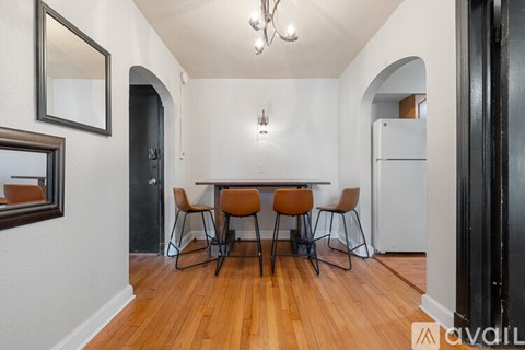 A dining area with a table and chairs.