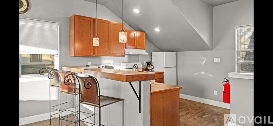 A kitchen with wooden cabinets and a white refrigerator.