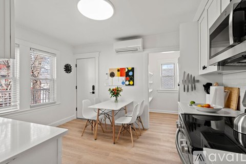A kitchen with a table and chairs in the middle of the room.