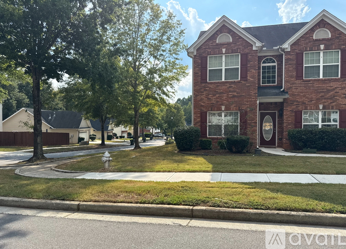 A red brick house with a white door and windows.