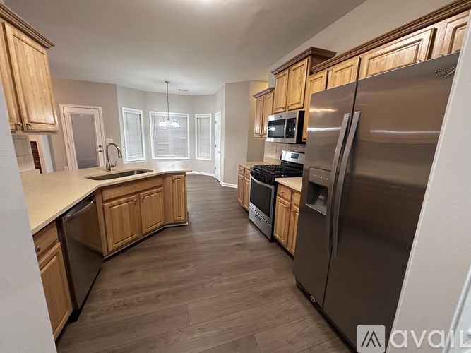 A kitchen with wooden cabinets and stainless steel appliances.