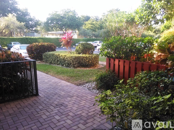 A red brick pathway leads through a landscaped area.