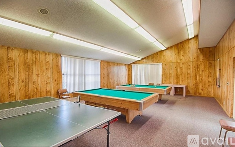 A room with a pool table and a ping pong table.