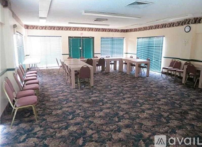 A conference room with a long table and chairs.