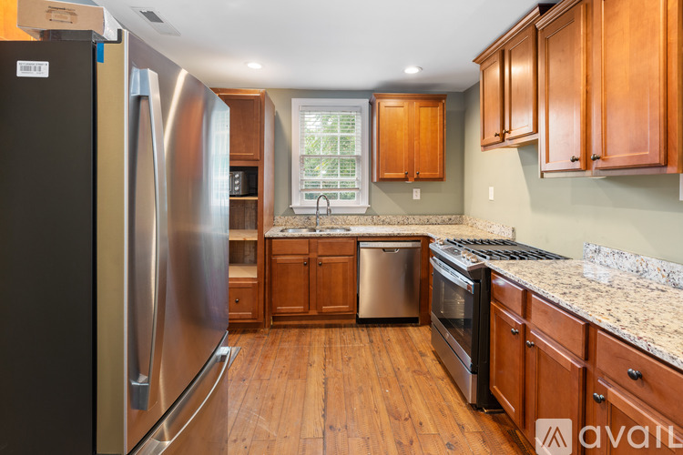A kitchen with wooden cabinets and a granite countertop.
