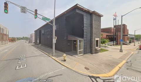 A street view of a building with a "One Way" sign above it.