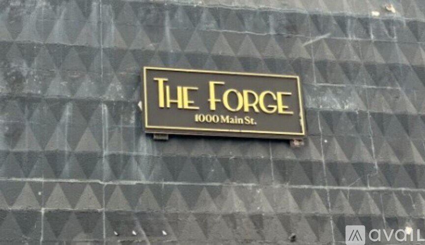 A sign on a building that says "The Forge 1000 Main St.".