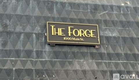 A sign on a building that says "The Forge 1000 Main St.".