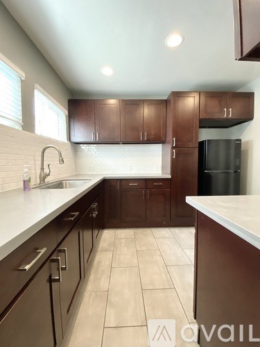 A kitchen with brown cabinets and a white countertop.