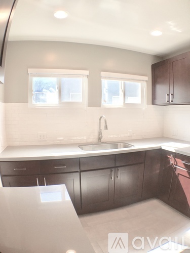 A kitchen with brown cabinets and a white counter top.