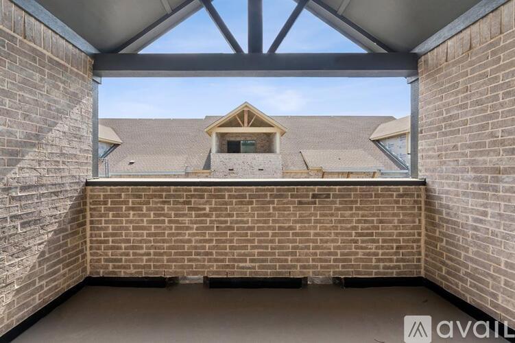A view from the inside of a building looking out to a roof with a skylight.