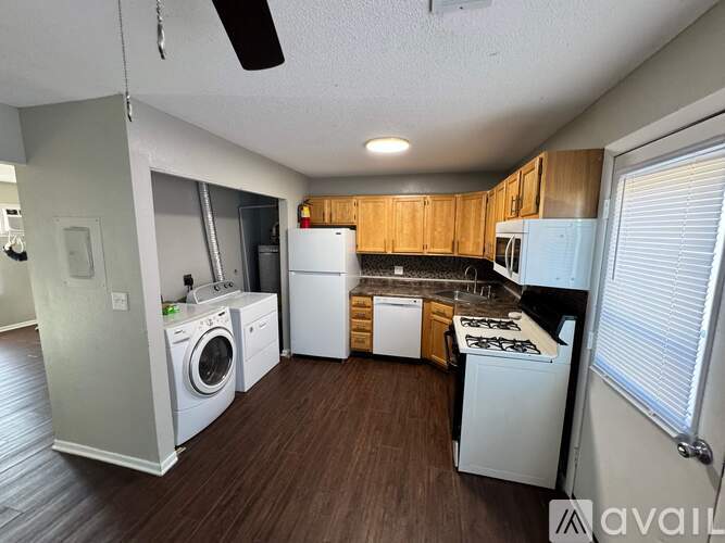 A kitchen with a washer and dryer built in.