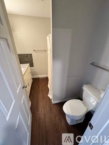 A small bathroom with a toilet and a shower stall.