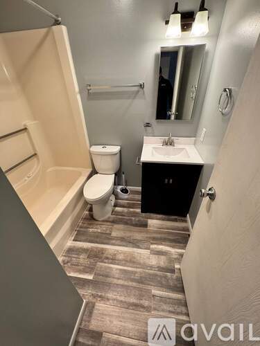 A bathroom with a toilet, sink, and bathtub.