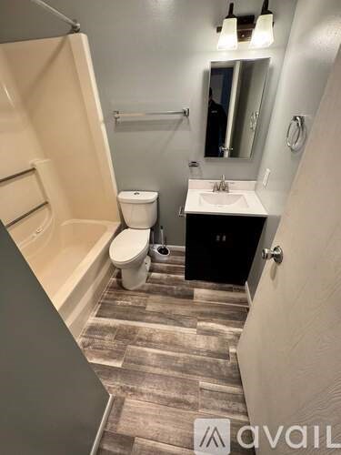 A bathroom with a toilet, sink, and bathtub.