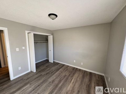 A room with a wooden floor and a ceiling light.