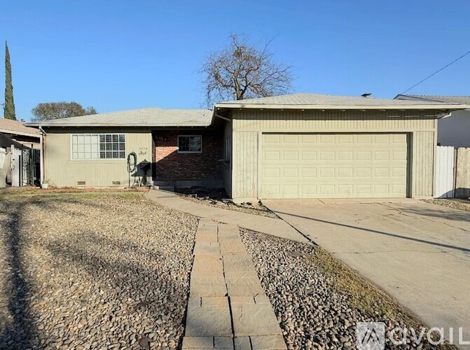 A house with a garage and a driveway in front.