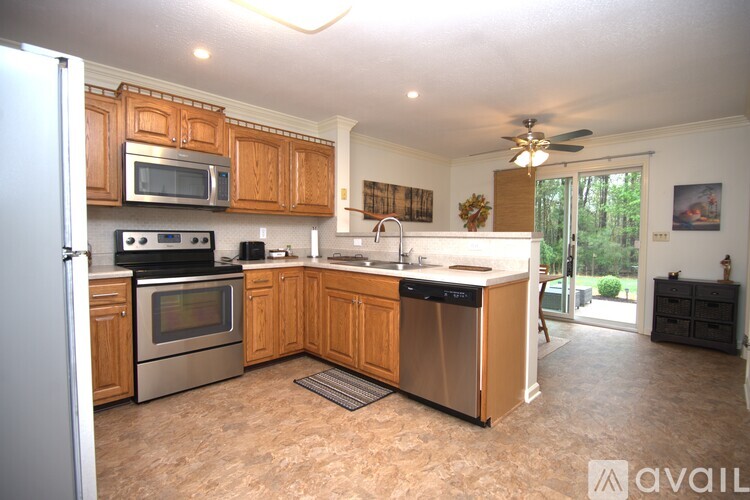 A kitchen with wooden cabinets and stainless steel appliances.