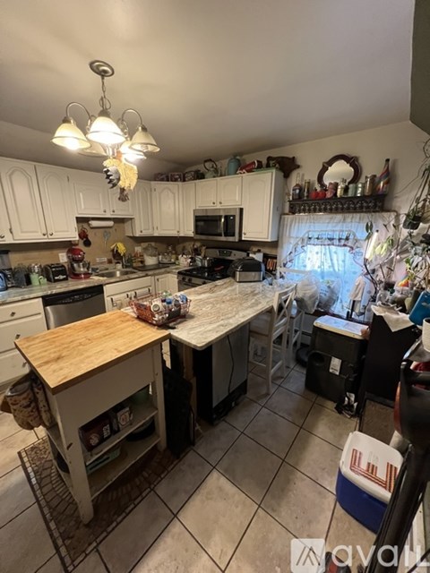 A kitchen with white cabinets and stainless steel appliances.