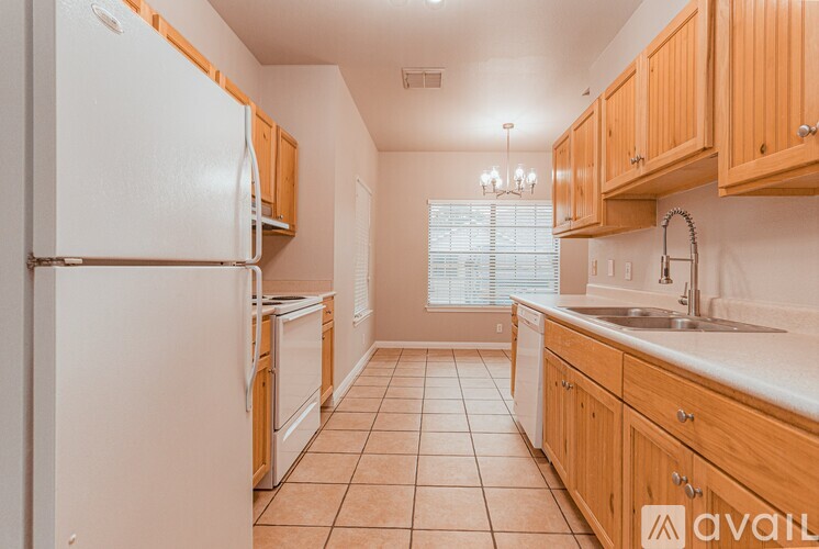 A kitchen with wooden cabinets and a white refrigerator.