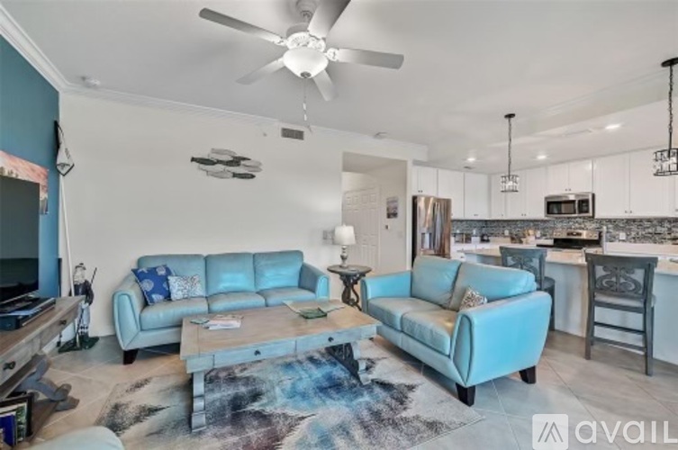 A living room with a blue couch and a television.
