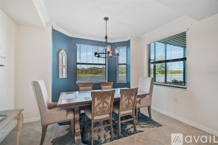A dining room with a table set for four.